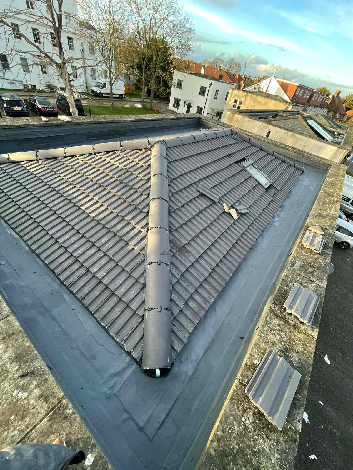 New concrete tile roof with ridge and flat roof detailing